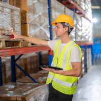 Warehouse workers with uniform working in distribution warehouse.